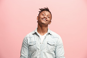 Image showing The happy business man standing and smiling against pink background.