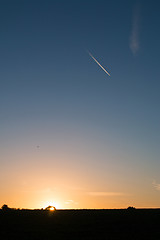 Image showing Sunrise and Plane Trail