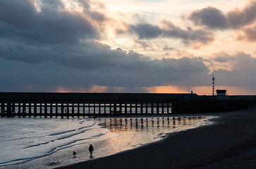 Image showing Sunset Beach with Dog Walker at Newhaven