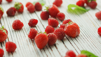 Image showing Raspberries and strawberries on table