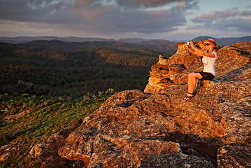 Image showing Woman taking a selfie with phone in mountain landscape