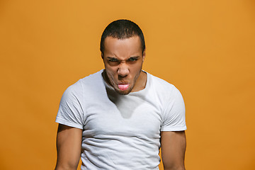 Image showing The young emotional angry and scared man standing and looking at camera