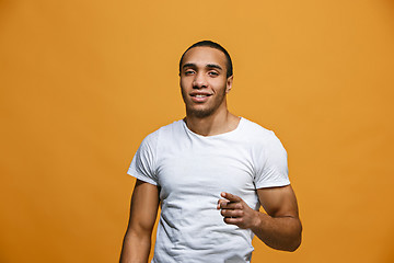 Image showing The happy business man point you and want you, half length closeup portrait on pink background.