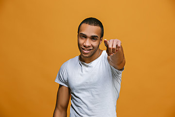 Image showing The happy business man point you and want you, half length closeup portrait on pink background.