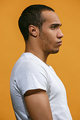 Image showing Serious Afro-American man is looking serious against orange background