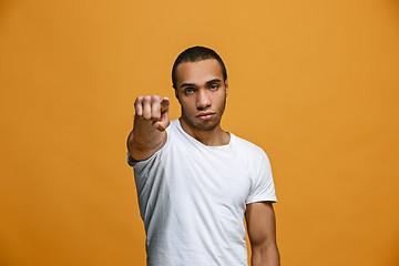 Image showing The overbearing businessman point you and want you, half length closeup portrait on orange background.