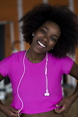 Image showing afro american woman running on a treadmill