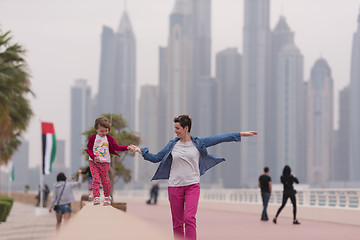 Image showing mother and cute little girl on the promenade