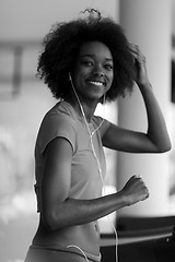 Image showing afro american woman running on a treadmill