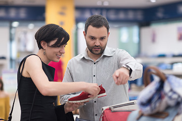 Image showing couple chooses shoes At Shoe Store