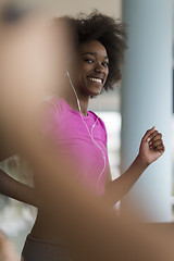 Image showing afro american woman running on a treadmill