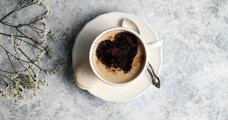 Image showing Cup of coffee with heart made of foam