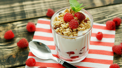 Image showing Served yogurt with raspberry on napkin