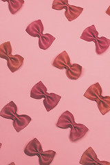 Image showing Pink pasta farfalle lies diagonally