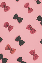 Image showing Pink and black pasta farfalle lies diagonally