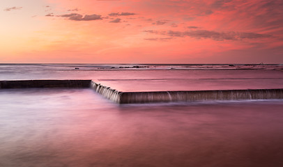 Image showing Sunrise skies and brilliant colour over rockpool