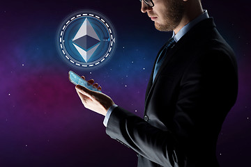 Image showing businessman with smartphone and ethereum hologram