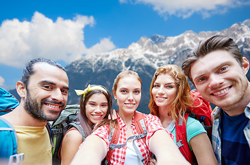 Image showing friends with backpack taking selfie over mountains