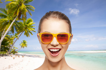 Image showing happy woman or teenage girl in sunglasses on beach