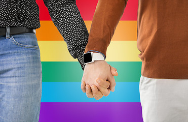 Image showing close up of male gay couple hands with smartwatch