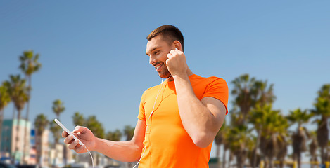 Image showing man with smartphone and earphones in los angeles