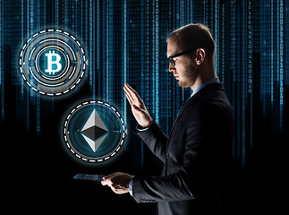 Image showing businessman with tablet pc and cryptocurrency