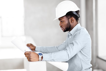 Image showing african architect in helmet with blueprint