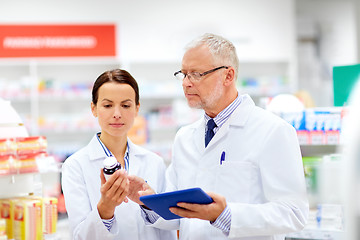 Image showing apothecaries with tablet pc and drug at pharmacy