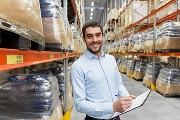 Image showing businessman with clipboard at warehouse