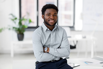 Image showing smiling african american businessman at office