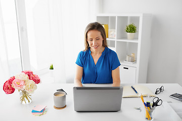 Image showing happy woman with laptop working at home or office