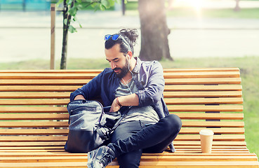 Image showing man with backpack and earphones in city