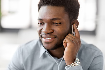 Image showing close up of man with earphones listening to music