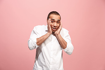 Image showing Handsome man looking suprised isolated on pink