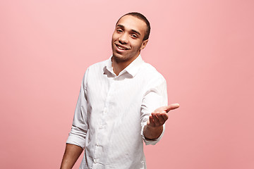 Image showing The happy business man point you and want you, half length closeup portrait on pink background.