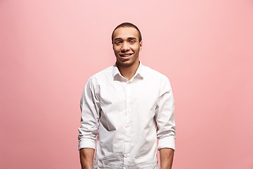 Image showing The happy business man standing and smiling against pink background.