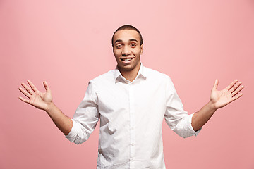 Image showing Handsome man looking suprised isolated on pink