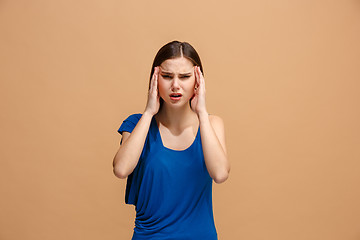 Image showing Woman having headache. Isolated over pastel background.