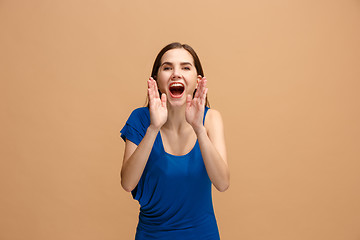 Image showing Isolated on pastel young casual woman shouting at studio