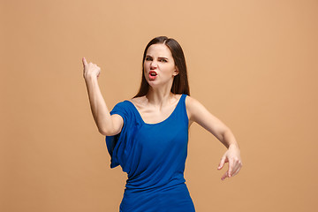 Image showing The young emotional angry woman screaming on pastel studio background