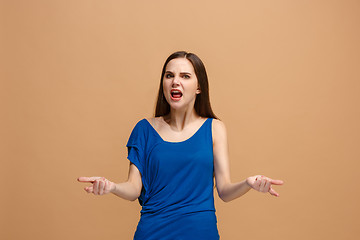 Image showing The young emotional angry woman screaming on pastel studio background