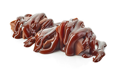 Image showing chocolate pieces covered with melted chocolate