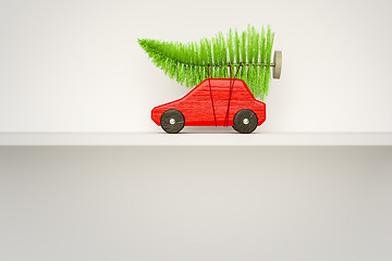 Image showing red toy car with green christmas tree 