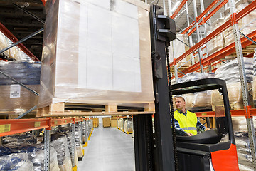 Image showing loader operating forklift at warehouse