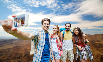 Image showing friends with backpack taking selfie by smartphone