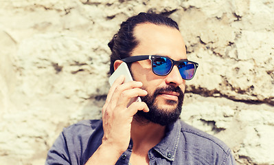 Image showing man with smartphone calling on city street