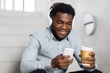 Image showing businessman with headphones and smartphone