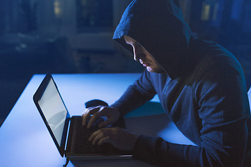 Image showing hacker using laptop computer for cyber attack