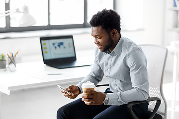 Image showing businessman with smartphone and coffee at office