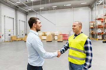 Image showing worker and businessman with clipboard at warehouse